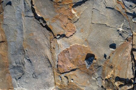 Texture of dark gray and black slate or background for design.Wall of a rock surface with an...