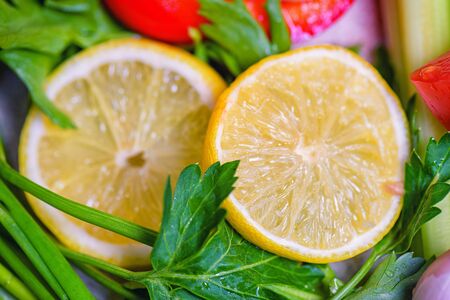 Cut lemon with greens. Healthy food. Yellow fresh lemon. Lemon. Concept of healthy eating.