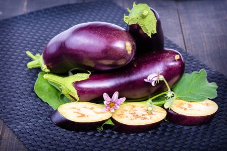 Eggplant on the table. Still life of eggplants. Dietary healthy food. Low-calorie product of healthy diet. Fresh sliced eggplant. Eggplant close up.の写真素材