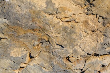 Brown stone with cracks on the surface or abstract background.の写真素材