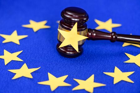 Ð¡ollapse of the European Union. UK exit from Europe. Judge's gavel on the table and the EU flag...