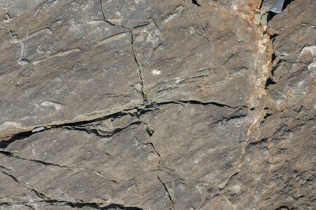 Texture of dark gray and black slate or background for design.Wall of a rock surface with an...