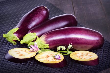 Eggplant. Fresh sliced eggplant. Dietary healthy food. Eggplant on the table. Delicious pieces of eggplant on a beautiful napkin, lying on the table.の写真素材