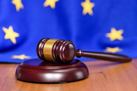 Mild brexit Europe. Collapse of the European Union. EU flag on the background of the judge's gavel. Free Europe and out of it.の写真素材