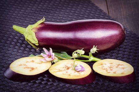 Eggplant on the table. Eggplant. Fresh sliced eggplant. Delicious pieces of eggplant on a beautiful napkin, lying on the table.Dietary healthy food.の写真素材