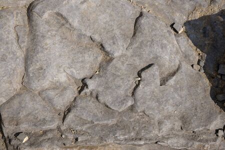 Texture of a dark gray granite stone or background for design.
The surface of the stone from the texture surfaces for the tiles.の写真素材