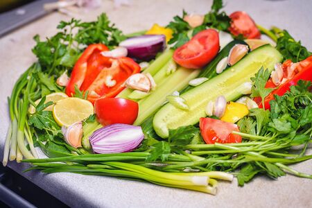 Colorful vegetables background.Still life of fresh fruits: pepper, lemon, tomato, cucumber, onion, green onion, parsley, garlic, celery. Fresh vegetables. Concept of healthy eating.の写真素材