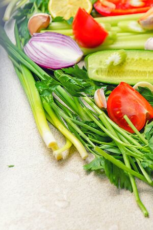 Fresh vegetables. Ð¡oncept of healthy eating.Vegetables. Still life of fresh fruits: pepper, lemon, tomato, cucumber, onion, green onion, parsley, garlic, celery.の写真素材