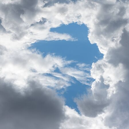 The blue sky with white clouds, in the rays of sunlight.の写真素材
