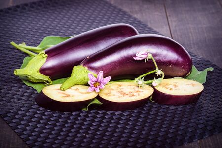 Eggplant on the table. Delicious pieces of eggplant on beautiful napkin, lying on the table.Eggplant. Fresh sliced eggplant. Dietary healthy food. の写真素材