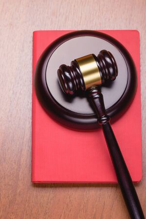 Red Book of the Criminal Code. Book for records. Fair trial. Judge's wooden gavel on the table. Right to a lawyer. Judicial law.の写真素材