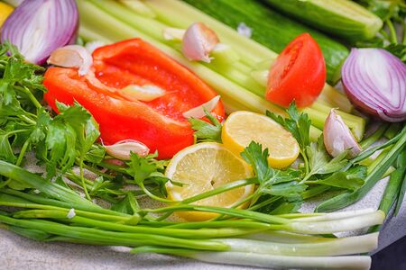 Colorful vegetables background.Still life of fresh fruits: pepper, lemon, tomato, cucumber, onion, green onion, parsley, garlic, celery. Fresh vegetables. Concept of healthy eating.の写真素材