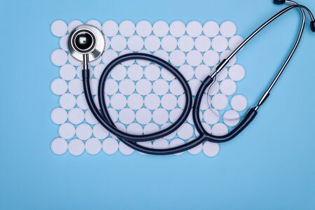 Pharmacy theme, pills white medication pills antibiotics. Blue background white pills with a medical...