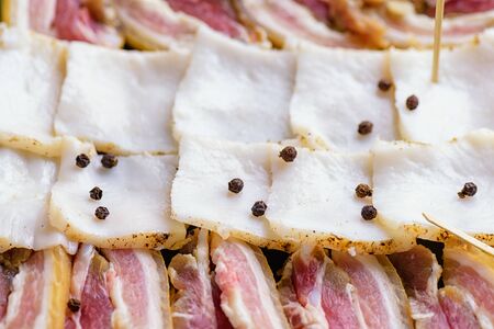 Bacon slices on the table. Sliced bacon with pepper.の写真素材