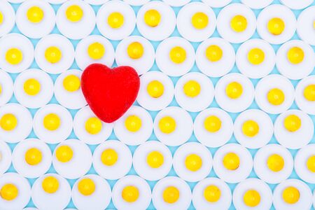 Red heart pills in the background.Background of drugs on a blue background.Concept of healthy eating.Top view of fish oil for good health on a white background from pills.の写真素材