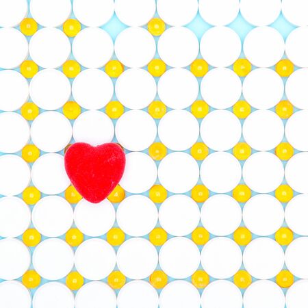 Red heart pills in the background.Bowl of fish oil on a white background close-up. Ð¡oncept of healthy eating.の写真素材