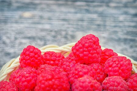 Red raspberries. Raspberry close-up on the table. Ripe red berry. Healthy and tasty food. Raspberries in basket on the table. の写真素材