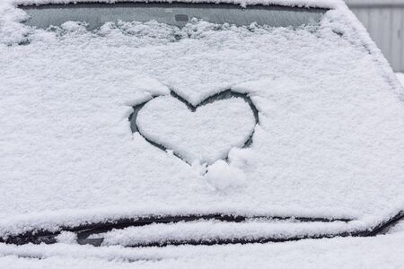 Heart of snow on windshield. Snow heart. Valentine on the glass. Snow, heart, frosty day.の写真素材