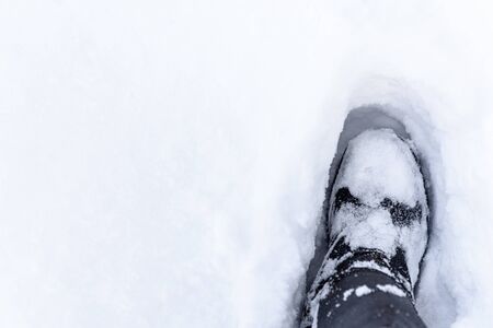 Boot in the snow. Footprint in the snow. White snow.の写真素材