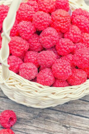 Ripe red berry. Raspberry close-up on the table. Healthy and tasty food. Red raspberries. Raspberries in basket on the table.の写真素材