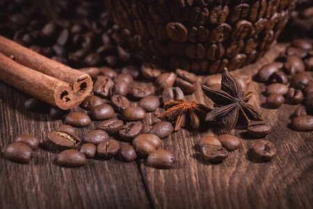 Coffee Coffee Beans Cinnamon Stick Anise Star Wooden Table Close-up. Background for coffee beans in dark colors for the background.の写真素材