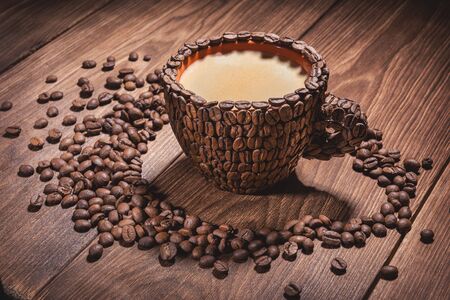 Coffee cup with coffee made from coffee beans wooden table. Close-up Cups. Natural coffee beans arabica. Coffee Cup Table Tree Coffee Grain Side view Close-up.の写真素材