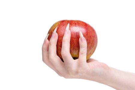 White background close-up apple. More natural nails, concept healthy lifestyle. Caring for the health of hands and nails. Woman Hands Natural Nails, closeup. Beautiful female hand holds an apple. Healthy eating concept. Hand of young woman with natural nails holds natural apple.の写真素材