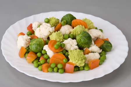 Vegetables on a beautiful white plateの写真素材