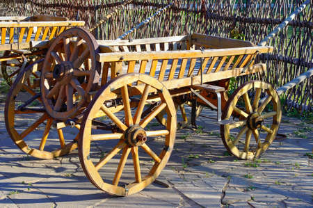 Old wooden cartage cart near fenceの写真素材
