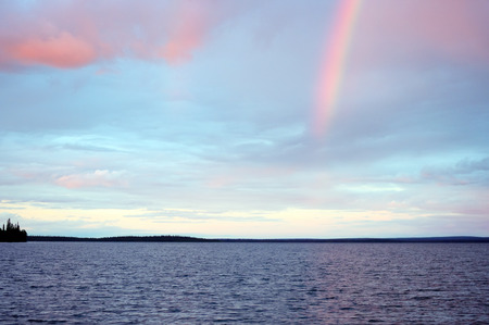 Rainbow in the sunset over lake Seydyavr behind the Arctic Circle on the Kola Peninsulaの写真素材