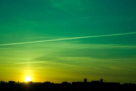 Silhouette of the roofs of houses at sunset.の写真素材