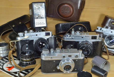 Moscow, Russia, 01. 31. 2022: Old film cameras Zorkiy-C, Zorkiy-4, Zorkiy-4K, Mir , on a wooden...