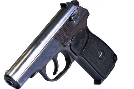 isolated combat black pistol with cartridges on a white backgroundの写真素材