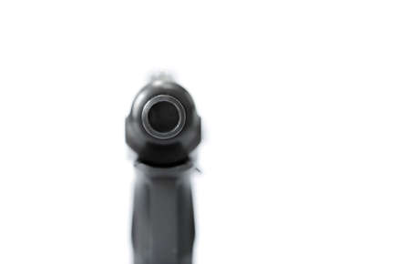 isolated combat black pistol with cartridges on a white backgroundの写真素材