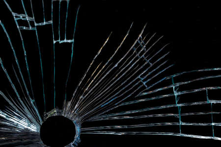 a crack on a broken glass mirror, on a black background in the form of an abstraction as a drawing...