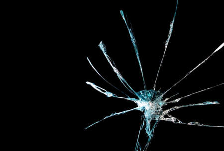 broken mirror glass on a black background in cracks in the form of an isolated image abstractionの写真素材