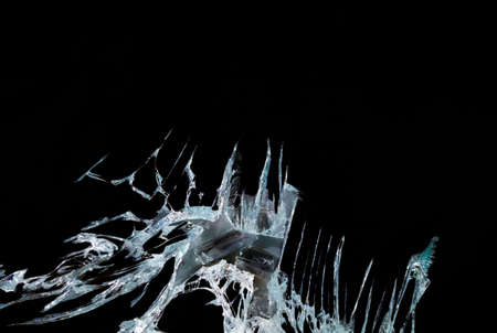 broken mirror glass on a black background in cracks in the form of an isolated image abstractionの写真素材