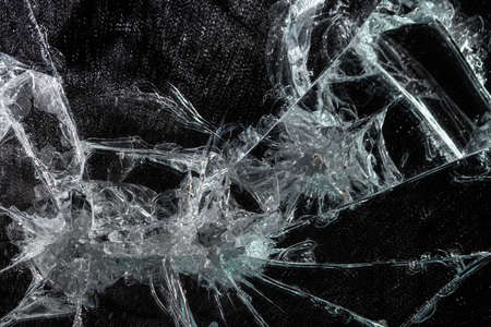 broken glass mirror in the form of cracks and lines on a black isolated backgroundの写真素材