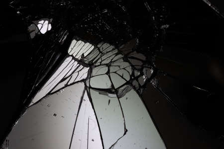 broken mirror glass cracks in the form of lines and abstractions on an isolated black backgroundの写真素材
