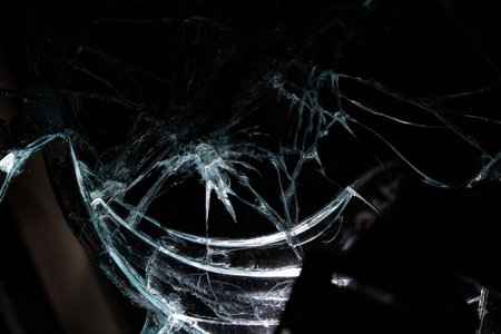 broken mirror glass cracks in the form of lines and abstractions on an isolated black background