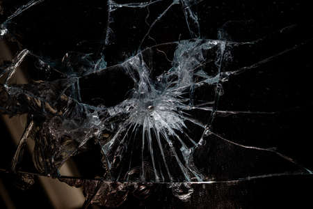 broken mirror glass cracks in the form of lines and abstractions on an isolated black backgroundの写真素材