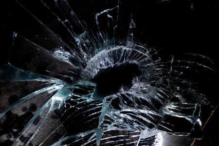 broken mirror glass cracks in the form of lines and abstractions on an isolated black backgroundの写真素材