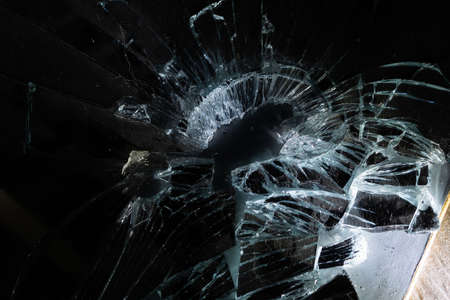 broken mirror glass cracks in the form of lines and abstractions on an isolated black backgroundの写真素材