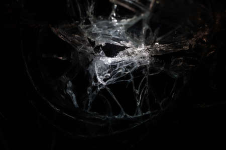 broken mirror glass cracks in the form of lines and abstractions on an isolated black backgroundの写真素材