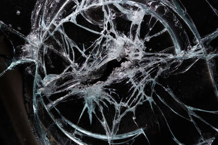 broken mirror glass cracks in the form of lines and abstractions on an isolated black background