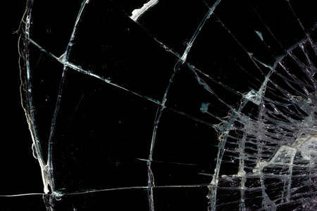broken mirror glass cracks in the form of lines and abstractions on an isolated black backgroundの写真素材