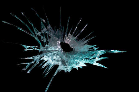 broken mirror glass cracks in the form of lines and abstractions on an isolated black backgroundの写真素材