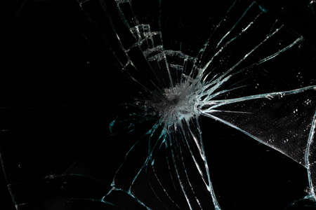 broken mirror glass cracks in the form of lines and abstractions on an isolated black backgroundの写真素材