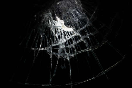 broken mirror glass cracks in the form of lines and abstractions on an isolated black backgroundの写真素材