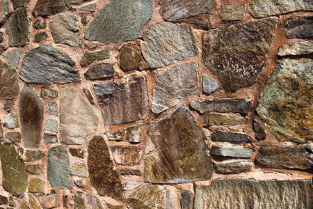 ancient masonry of cobblestones and stones for the sidewalk wall and road, street of the ancient cityの写真素材